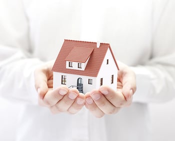 Image of a home in the hands of a caring person - having a sober companion in your home - what to expect with a live-in sober companion - hired power offers sober companion and sober coach resources 