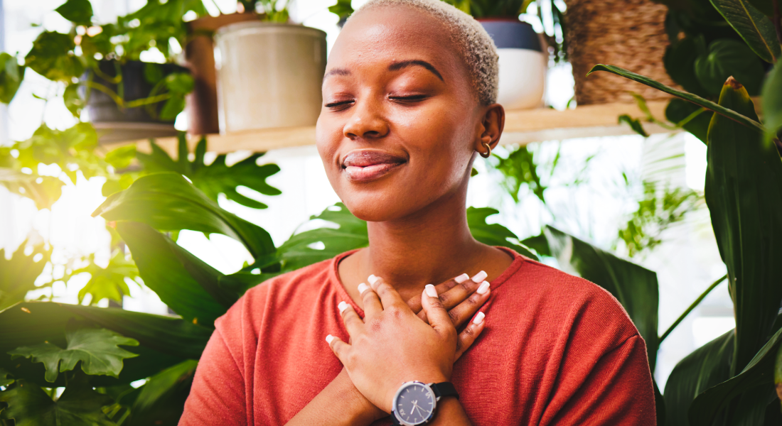 woman with her hands over her heart