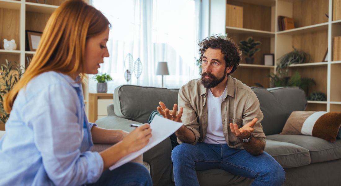 man talking to woman in an therapist office