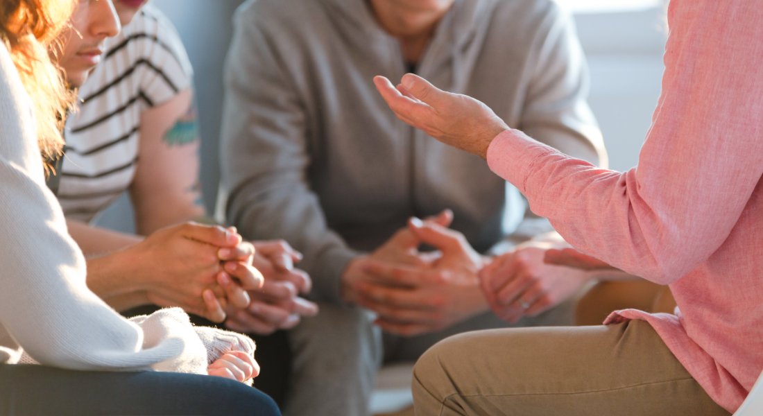 four people sitting in a circle