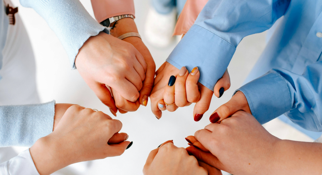 close up of hands held in a circle