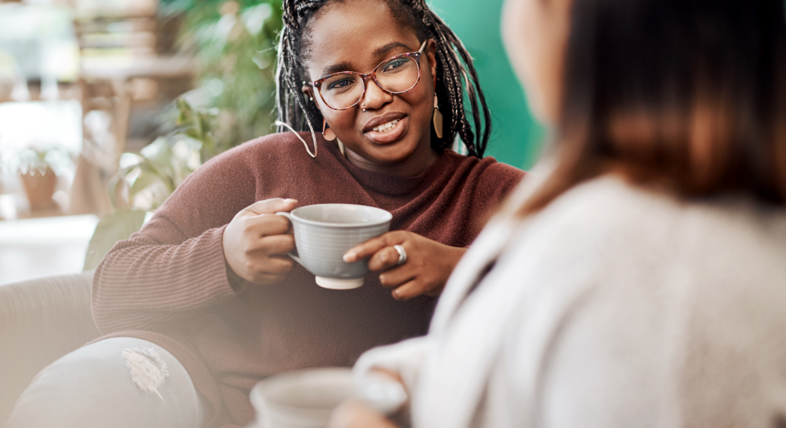 woman drinking tea talking with another woman