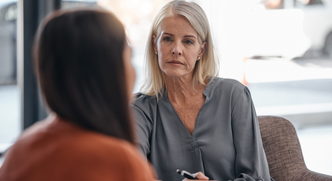 two women talking in chairs