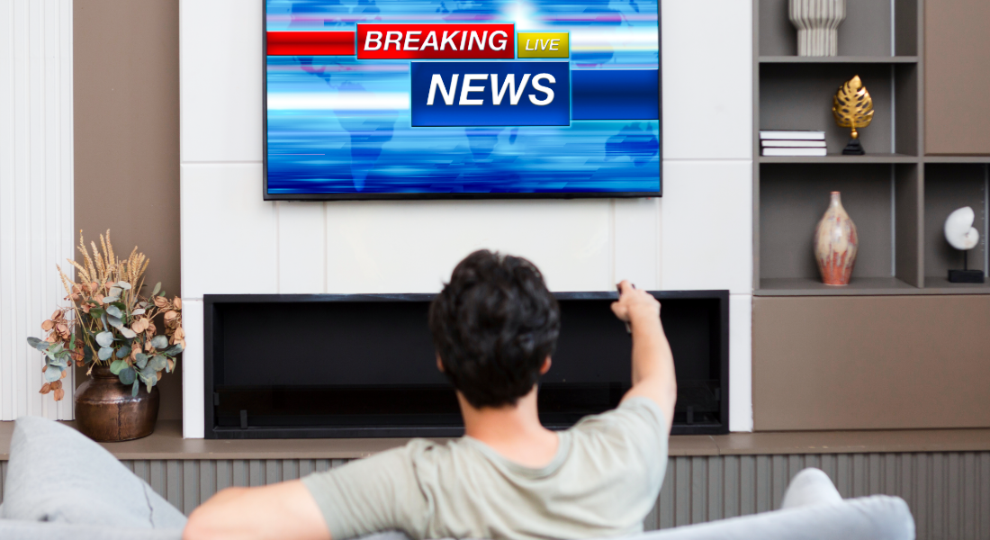 man watching the news on tv